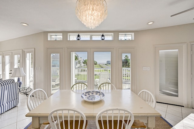 tiled dining area featuring ceiling fan with notable chandelier, a wealth of natural light, and french doors