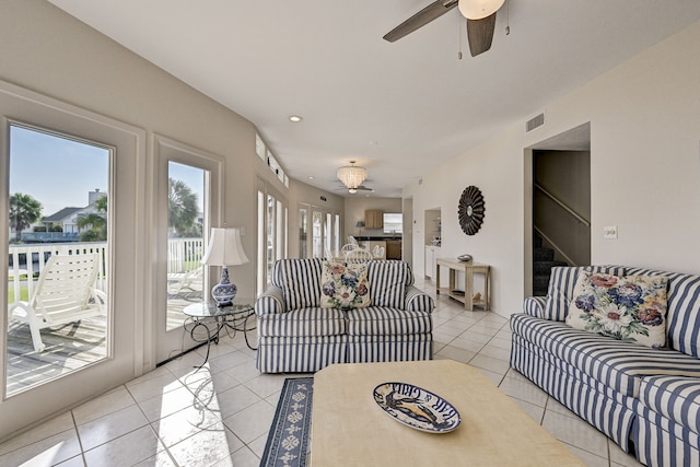 living room with light tile patterned floors and ceiling fan