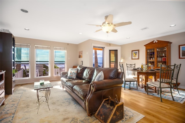 living room with light wood-type flooring and ceiling fan