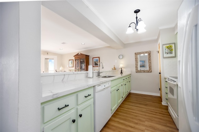 kitchen with white appliances, an inviting chandelier, sink, light stone countertops, and light wood-type flooring