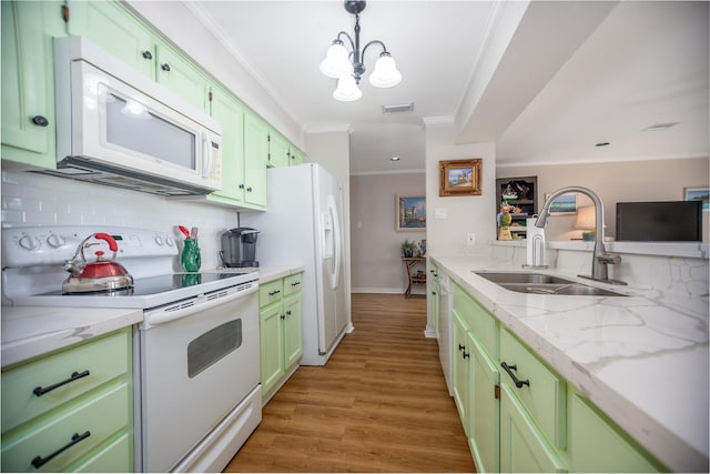 kitchen with white appliances, crown molding, sink, light stone countertops, and light hardwood / wood-style floors