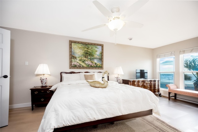 bedroom with light hardwood / wood-style floors and ceiling fan