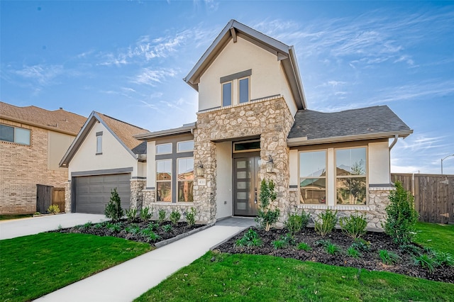 view of front of home with a front yard and a garage