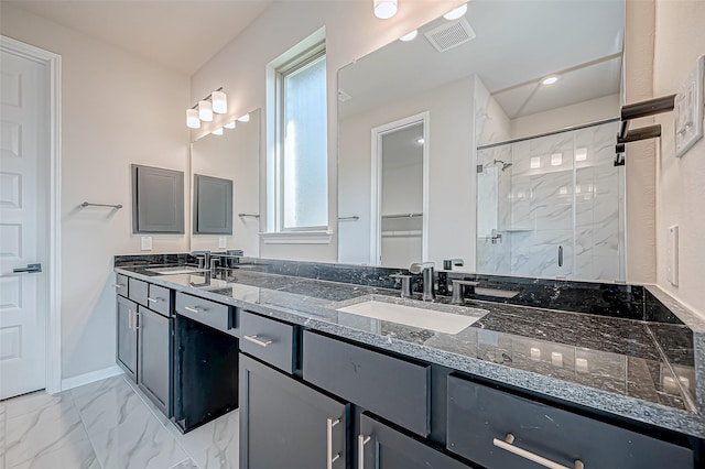 bathroom with vanity and a shower with shower door