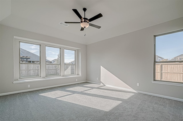 carpeted spare room with ceiling fan