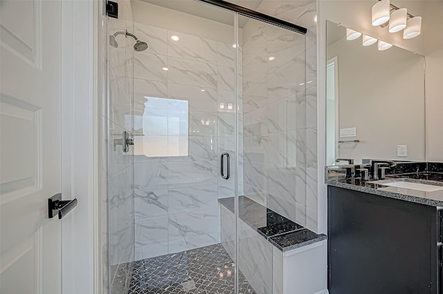 bathroom with vanity and a shower with shower door