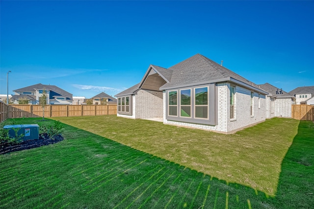 451 Papershell Path, Richmond, TX 77406 - back of property with a fenced backyard, brick siding, and a shingled roof