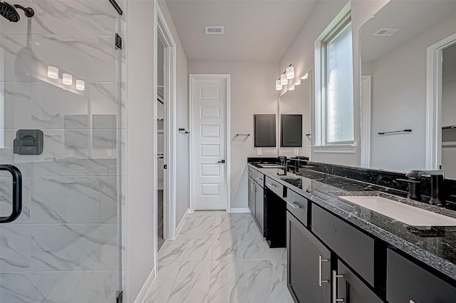 bathroom with vanity and a shower with door