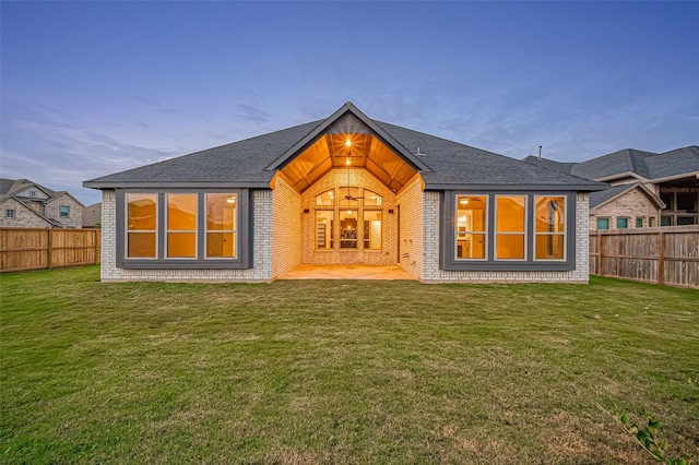 451 Papershell Path, Richmond, TX 77406 - back of property featuring brick siding, a fenced backyard, a shingled roof, and a patio area
