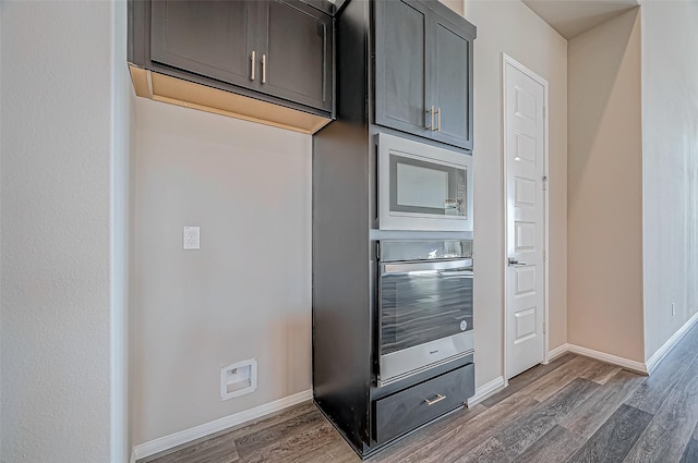 kitchen with appliances with stainless steel finishes and dark wood-type flooring