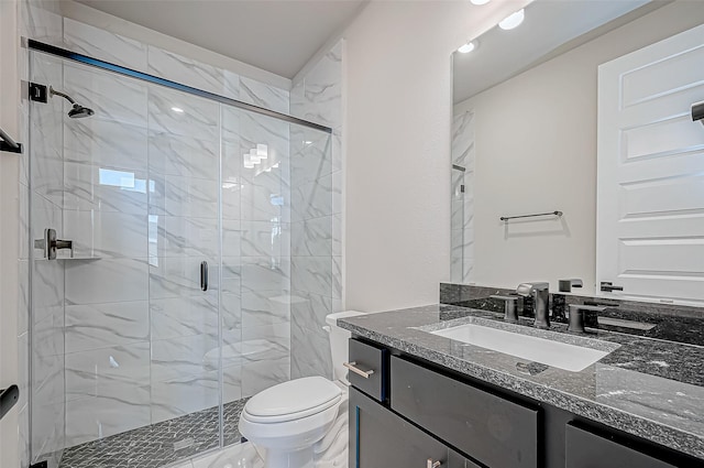 bathroom with vanity, a shower with shower door, and toilet