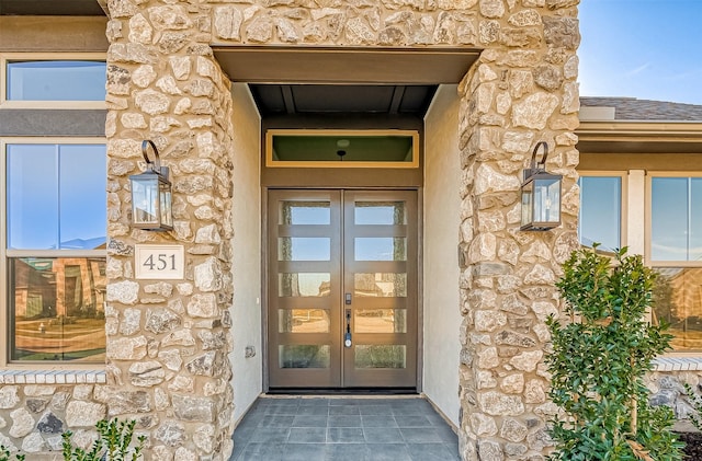 view of exterior entry featuring french doors