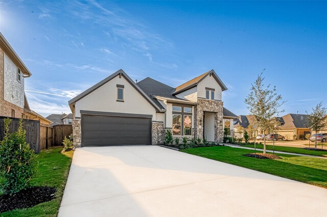 view of front of house featuring a garage and a front lawn