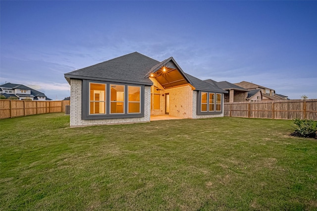 rear view of house featuring a lawn