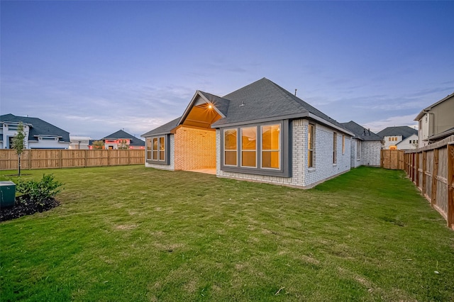 rear view of property with a lawn