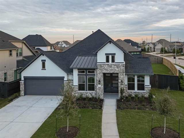 view of front of home featuring a yard and a garage