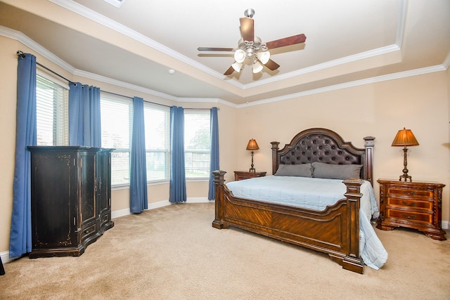 carpeted bedroom featuring a raised ceiling, ceiling fan, and crown molding