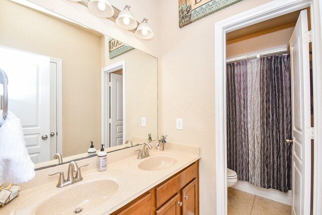 bathroom featuring tile patterned flooring, vanity, and toilet