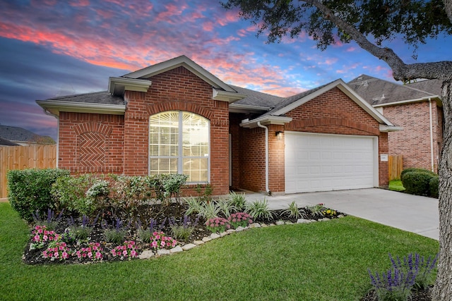 ranch-style house featuring a yard and a garage