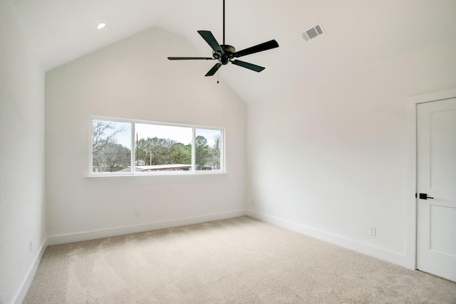 carpeted empty room featuring ceiling fan and high vaulted ceiling