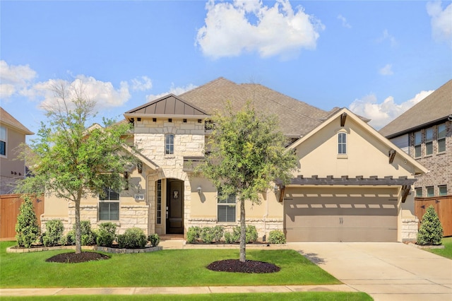 view of front of house with a front yard and a garage