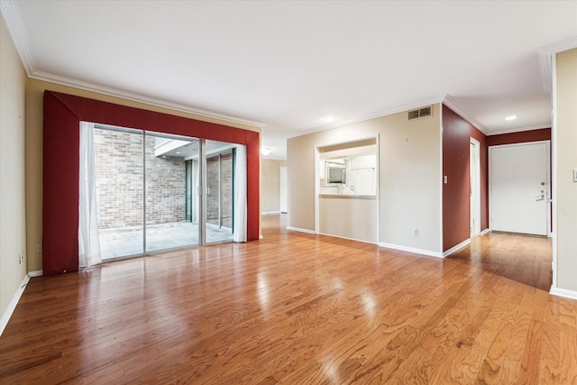 unfurnished room with light wood-type flooring and crown molding