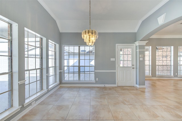 unfurnished dining area with light tile patterned floors, an inviting chandelier, a wealth of natural light, and crown molding