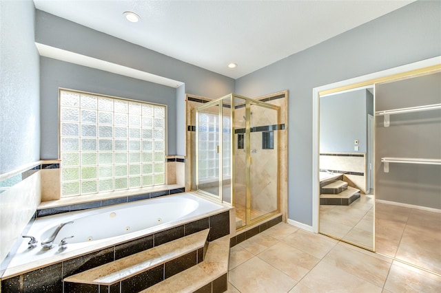 bathroom with tile patterned flooring and shower with separate bathtub