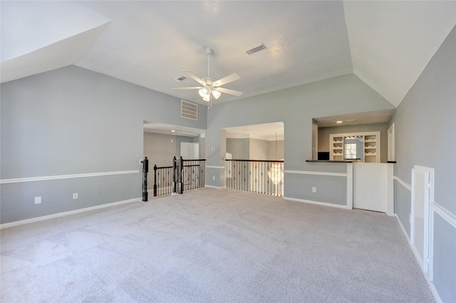 interior space with carpet flooring, ceiling fan, and vaulted ceiling