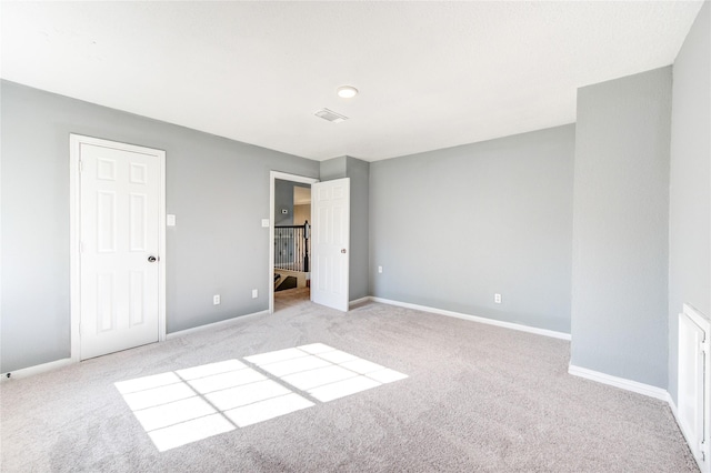 unfurnished bedroom with light colored carpet