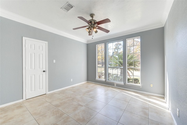 empty room with ceiling fan, ornamental molding, and light tile patterned floors