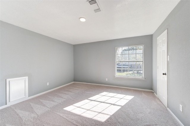 spare room with light colored carpet