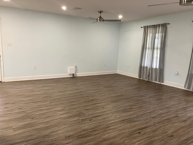 spare room with ceiling fan and dark hardwood / wood-style flooring