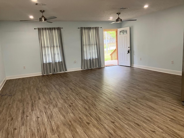 unfurnished living room featuring a textured ceiling and dark wood-type flooring