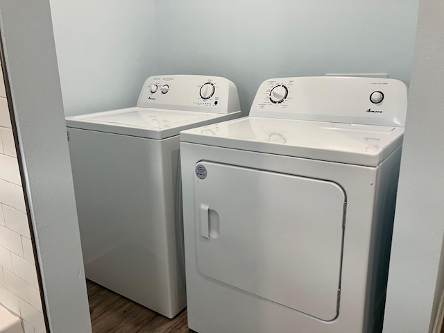 clothes washing area with hardwood / wood-style floors and independent washer and dryer