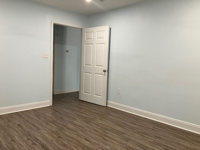 spare room featuring dark hardwood / wood-style flooring