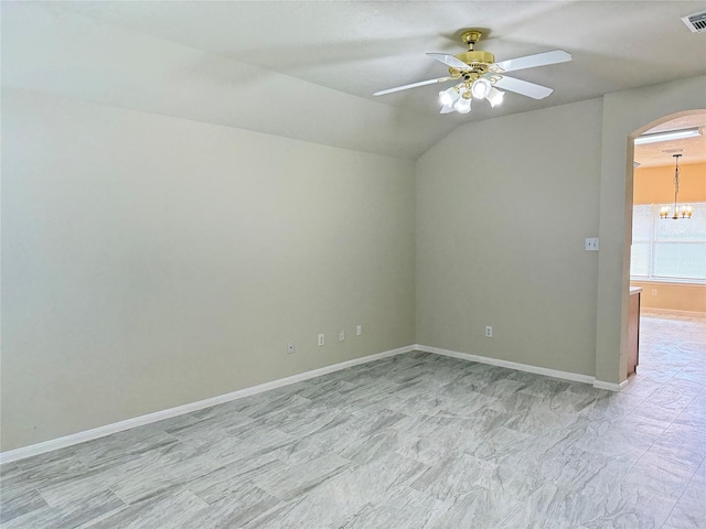 spare room with ceiling fan with notable chandelier and lofted ceiling