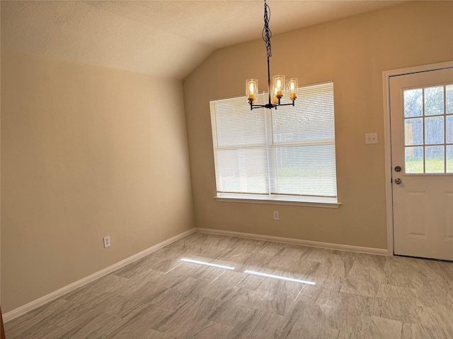 unfurnished dining area with a notable chandelier, a textured ceiling, and vaulted ceiling