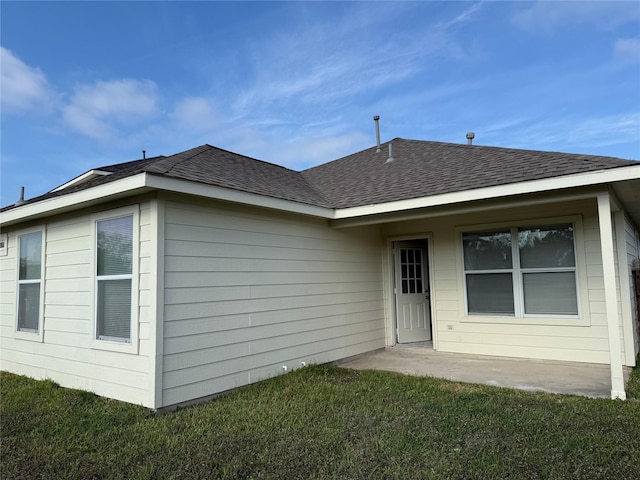 back of house featuring a patio and a lawn