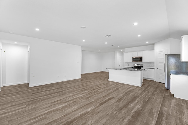 kitchen with a center island with sink, white cabinets, wood-type flooring, and appliances with stainless steel finishes