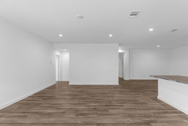 unfurnished living room with dark hardwood / wood-style flooring