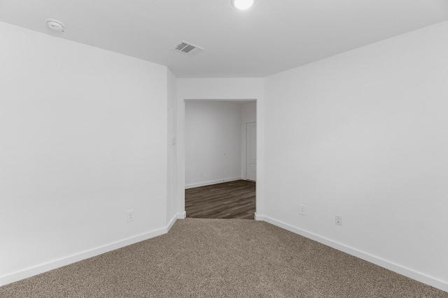 empty room with dark carpet