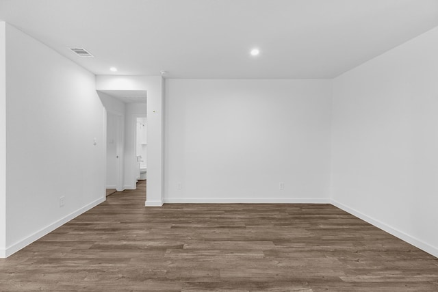 unfurnished room with dark wood-type flooring