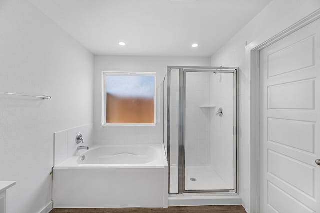 bathroom featuring wood-type flooring and independent shower and bath