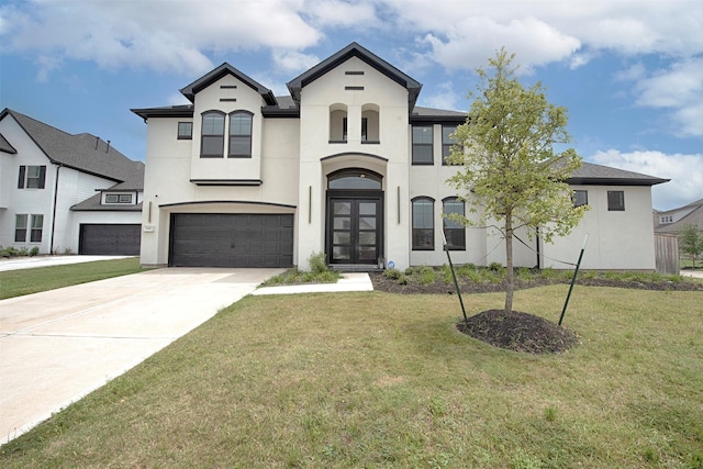 view of front of home featuring a front lawn, a garage, and french doors