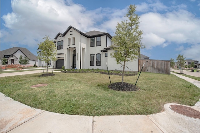 view of front facade featuring a front yard and a garage