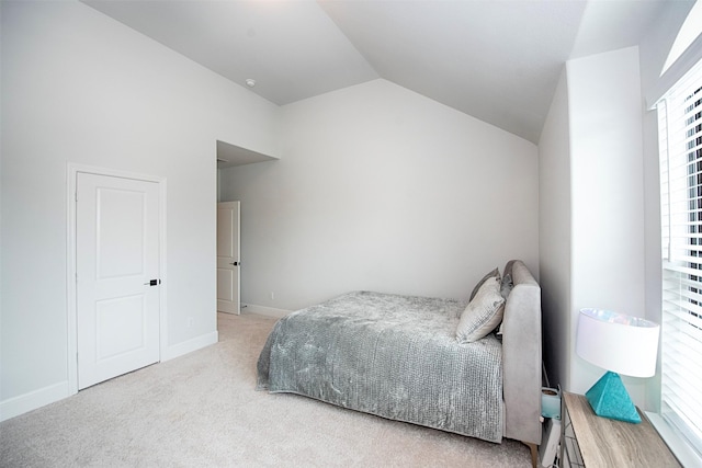 bedroom with light carpet and vaulted ceiling