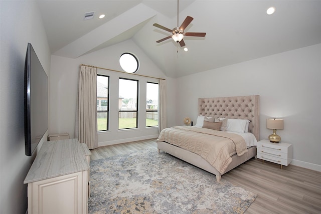 bedroom featuring light hardwood / wood-style floors, high vaulted ceiling, and ceiling fan