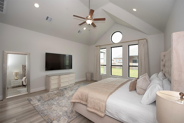 bedroom with ceiling fan, light hardwood / wood-style floors, and high vaulted ceiling