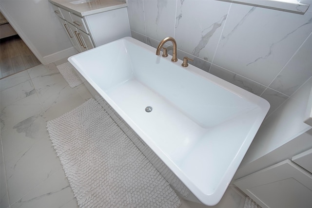 bathroom with a bath and tile walls